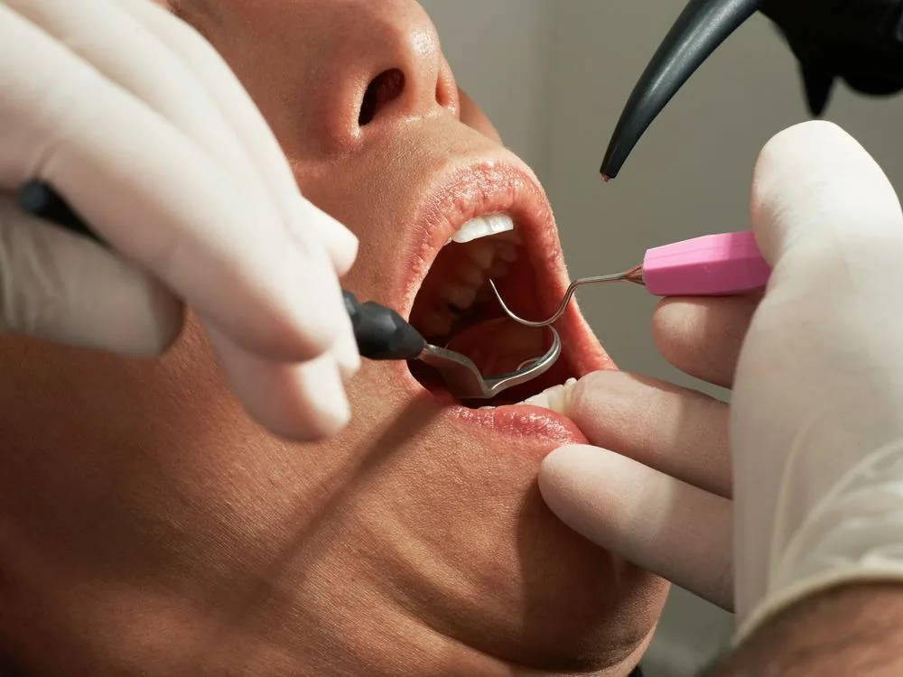 Hygienist performing an oral health assessment