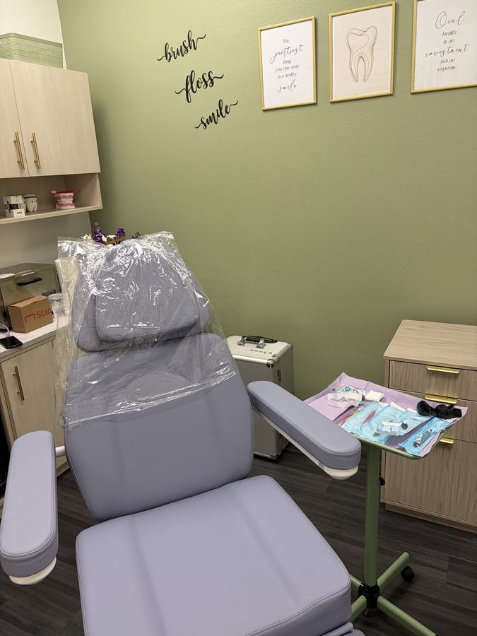 On Demand Dental hygiene chair beneath a "brush, floss, smile" wall decal